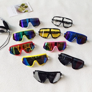 Detailed flat lay of colorful kids sports sunglasses for cycling and outdoor activities