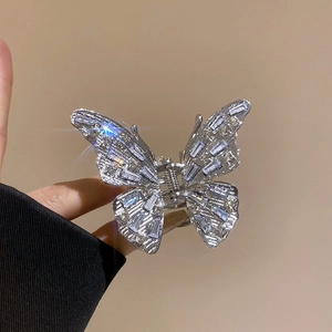 Close-up of a silver butterfly hair claw clip with sparkling rhinestones and crystal detail