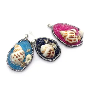 Detailed macro view of diamond-rimmed conch shell pendants in blue, pink and black colors