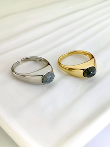 Detail of vintage silver and gold open rings with oval grey natural labradorite stones