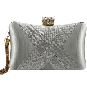 Silver woven metal evening clutch bag with sparkling rhinestone clasp and gold tassel