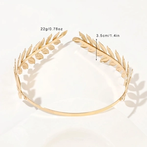 Detailed macro shot of golden laurel leaf crown showing delicate metal texture and polished finish
