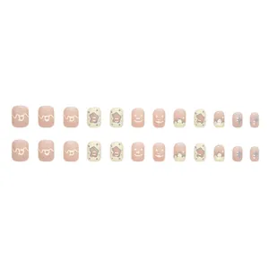 Short square press-on nails with pale pink, yellow smiley faces and blue stars designs