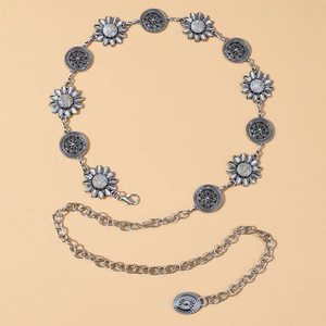 Detail of vintage silver waist chain featuring sunflower charms and hollow circular patterns