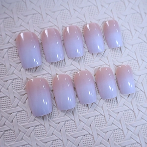 Short square gradient press-on nails in soft peach and lavender purple with glossy finish