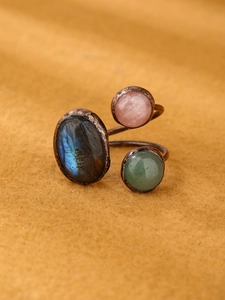 Detailed macro view of bohemian three-stone ring with labradorite and rose quartz stones