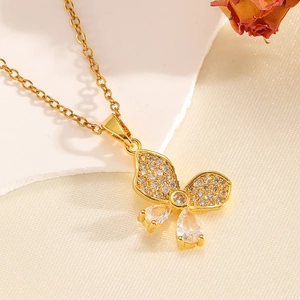 Macro close-up of gold butterfly pendant with diamonds and pearls on soft fabric