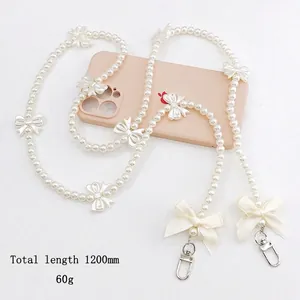 Cream pearl crossbody phone chain with bow decoration and silver metal clasps, 120cm length