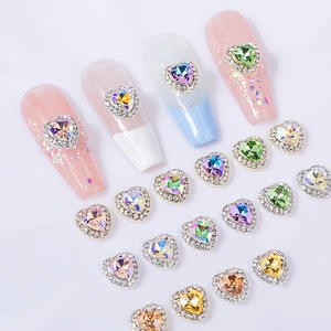 Faceted heart-shaped nail art crystals with zircon micro-pave in multiple aurora colors