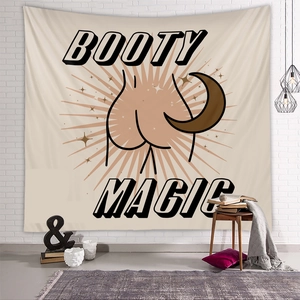 Detail of BOOTY MAGIC wall tapestry hanging on a white brick wall with cozy home decor