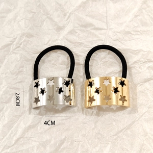 Macro view of gold and silver star cutout hair cuffs with 2.8cm by 4cm dimensions