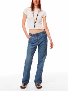 Detail of white knit cropped tee paired with blue denim jeans on a model