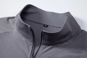 Close-up of gray sun protection shirt showing half-zip collar and precision stitching