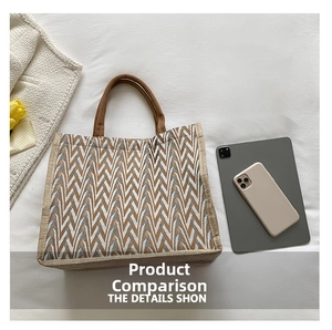 Detail of striped woven tote bag with V-shaped geometric patterns and rope handles