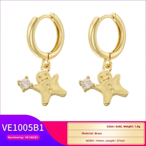Detail view of gingerbread man gold earring with brass material and size measurements