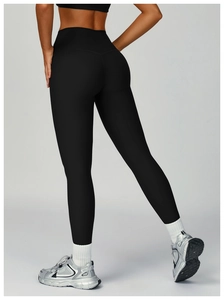 Close-up of the high-waisted ribbed fabric and butt-lifting texture on black yoga leggings