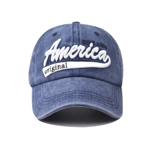 Detail of America embroidery and EST.1964 stitching on washed blue cotton baseball cap