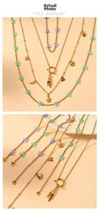 Detail of 18K gold stainless steel butterfly necklace with starfish and shell pendants