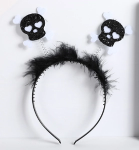 Detail of Halloween headband featuring spring-loaded skulls and white feather trim decor