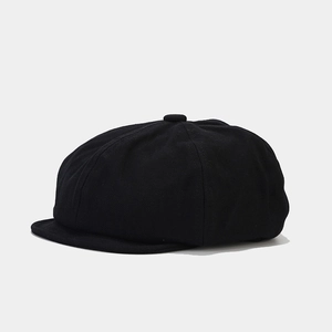 Side view detail of a classic black newsboy cap featuring a minimalist vintage silhouette