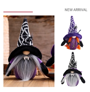 Macro detail of Halloween gnomes featuring vampire fangs and black spider ornaments