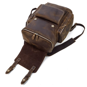 Detailed top view of vintage brown crazy horse leather backpack with multiple zip pockets