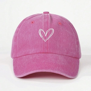 Pink washed cotton baseball cap with white embroidered heart on a clean white background