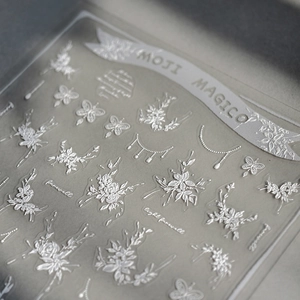 3D embossed white lace flower and butterfly nail art stickers with elegant floral motifs
