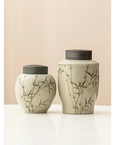 Detail of emerald green bamboo ceramic tea canisters with airtight alloy lids in two sizes