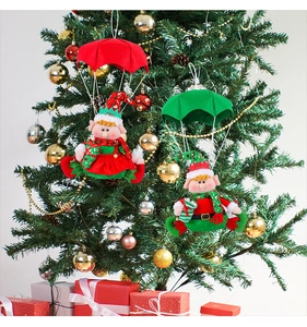 Detailed view of red and green parachute elf hanging ornaments on a decorated Christmas tree