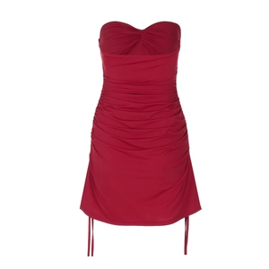 Detail of red ruched bodycon dress showing side drawstring and adjustable hemline texture