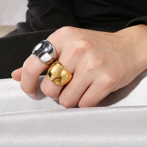 Polished 18K gold and silver chunky stainless steel rings set for men on silk background