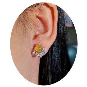 Luxury earrings with square yellow gemstone and teardrop zircon accents on model