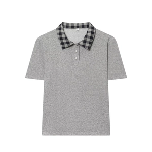 Close-up of gray knit polo shirt with checkered collar and sparkling rhinestone buttons