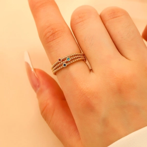Three-layer hollow ring set with multicolored zircon stones in gold beaded finish
