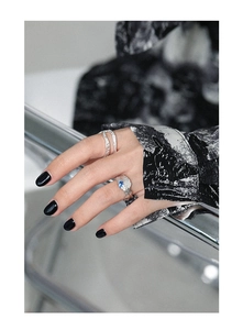 Detail of irregular S925 silver ring with blue zircon stones on model's hand