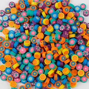 Close-up of colorful polymer clay spacer beads with floral patterns for DIY jewelry making