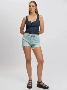 Detail of dark blue ribbed tank top with button trim paired with ripped denim shorts