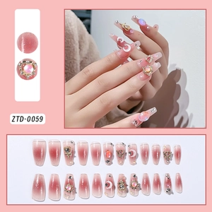 Detailed pink gradient press-on nails with moon, star charms and crystal decorations
