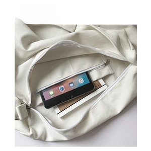 Interior view showing large capacity storage with zipper pocket in canvas tote bag