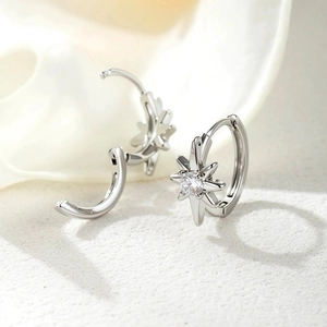 Elegant silver star hoop earrings with clear round gemstone inlay on white seashell