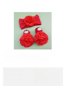 Detail of baby red floral headband and non-slip socks set made of cotton nylon blend