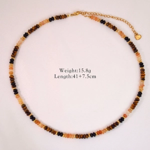 Detail of tiger eye bead necklace with length 41+7.5cm and weight 15.8g on white fabric