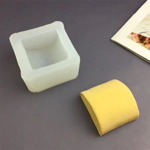 White silicone cat paw mold for making yellow crafts on a professional gray backdrop