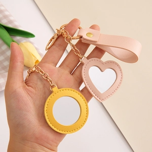 Creative PU leather heart and round mirror keychains with elegant gold floral accents