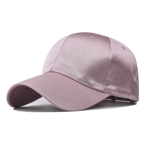 Close-up of pink satin baseball cap featuring glossy fabric and neat stitching detail