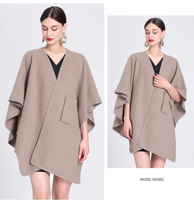 Detail shot of camel knit poncho cardigan featuring front pockets and asymmetric draping