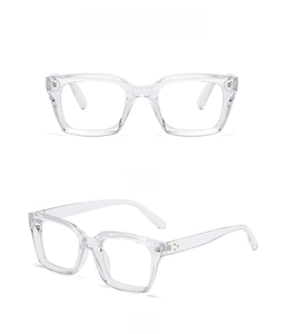 Detail view of transparent square frames and metal rivets on spring hinge reading glasses