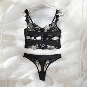 Detailed flat lay of black lace lingerie set with floral embroidery and mesh texture