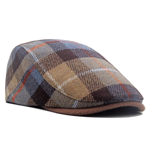 Detail shot of vintage wool blend newsboy cap with classic checkered pattern and texture